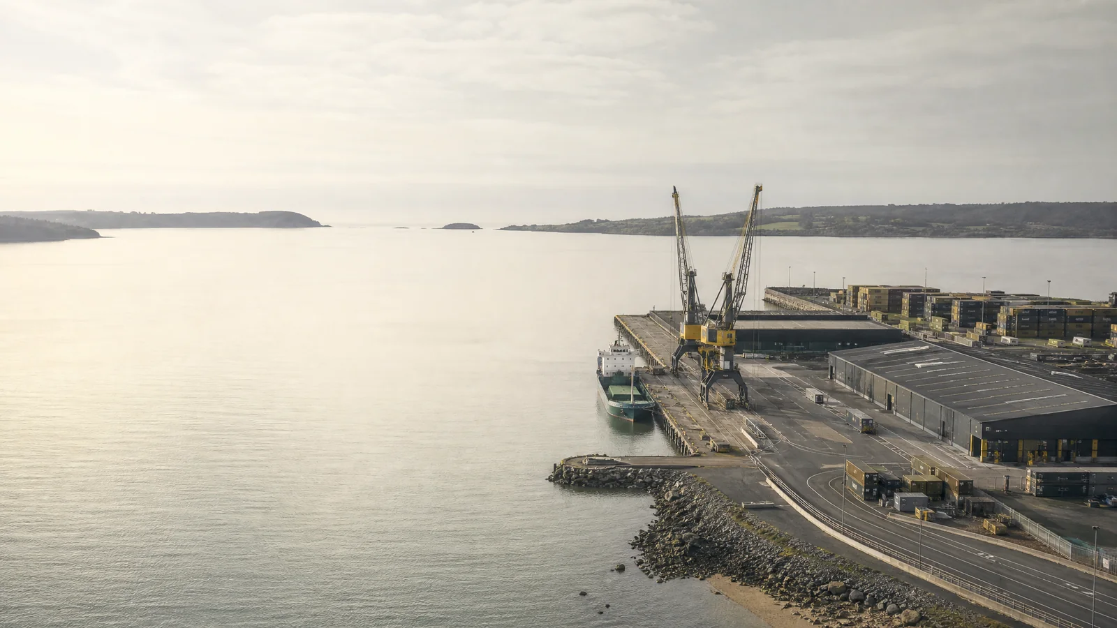 AI-generated illustrative coastal logistics hub with a container terminal and distribution warehouse.